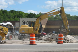 Kadlec Excavating backhoe at work in front of Shopko, Mora, MN.
