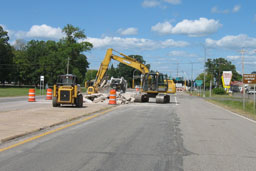 Kadlec Excavating John Deere backhoe and skidloader moving concrete. (long distance shot)