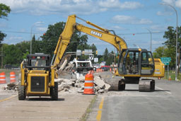 Kadlec Excavating John Deere backhoe and skidloader moving concrete. (close up)