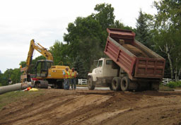 Kadlec Excavating backhoe and dumptruck at work.