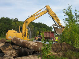 Kadlec Excavating backhoe positions culvert in exact location. (close up)