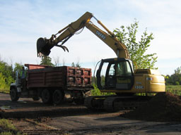 Kadlec Excavating drops topsoil into dumptruck.