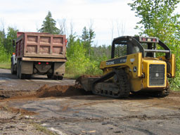 Kadlec Excavating Bobcat loader moves dirt.