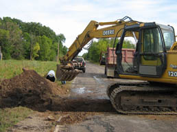 Kadlec Excavating crew attaches culvert union. (close up)